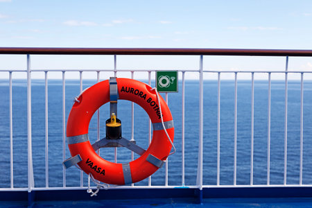 Vaasa, Finland - June 20, 2022: the railing of a boat with an orange lifebuoyの写真素材