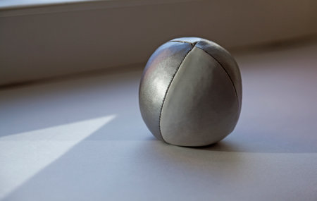 juggling ball in white and silver on windowsillの写真素材
