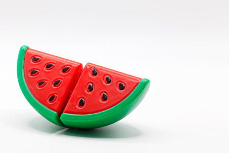 a plastic toy watermelon on a white backgroundの写真素材