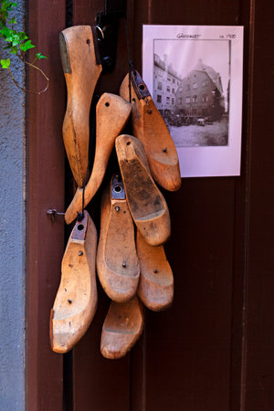 many templates for shoes made of wood hang outside the shoemaker's workshopの写真素材