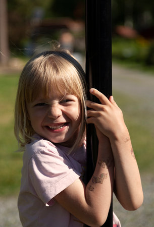 Umea, Sweden - June 9, 2023: happy guy holding on to climbing equipment for childrenのeditorial素材
