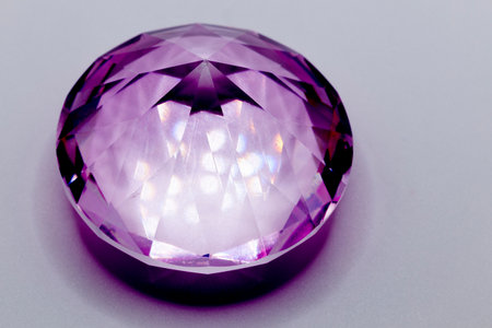 a purple diamond in glass for children to play with on light backgroundの写真素材