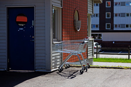 A commercial building entrance with shopping carts and modern architecture.の写真素材