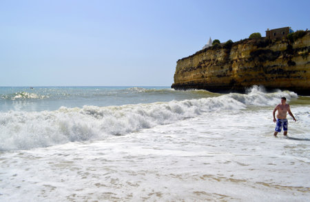 Senhora Da Rocha Beach, Algarve, Portugal - October 2, 2014 : Tourist enjoying the sea on Senhora Da Rocha Beach in Portugalのeditorial素材