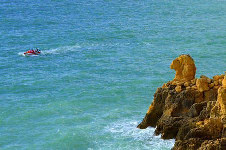 Ponta Da Piedade, Algarve, Portugal - October 28, 2015 : Tourists enjoying the view of the Camels head spectacular rock formations from a boatの写真素材