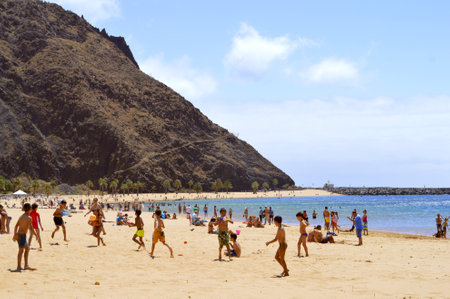 Playa De Las Teresitas beach, Tenerife, Canary Islands, Spain, Europe - June 14, 2016: Children playing on the beach enjoying the sunのeditorial素材