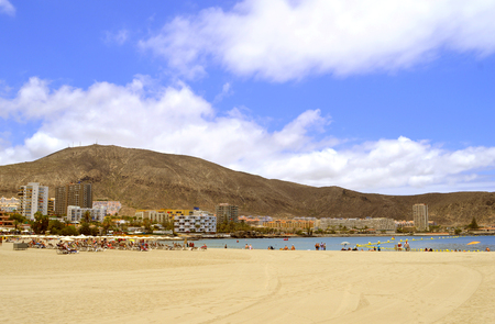 Tourists on the beach enjoying the sunの写真素材