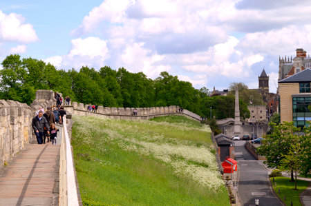 Tourists walking along York City Roman wall surrounding the Cityのeditorial素材