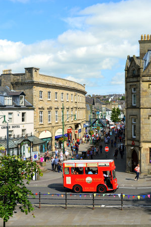Buxton tour bus taking tourists around the centre of Buxton townのeditorial素材