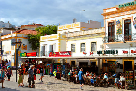 Tourists eating and drinking in restaurants in the old town of Albufeira, Portugalのeditorial素材