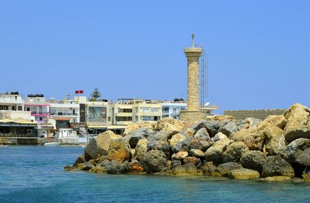 Hersonissos harbour lighthouse a popular tourist attraction in the Greek island Crete