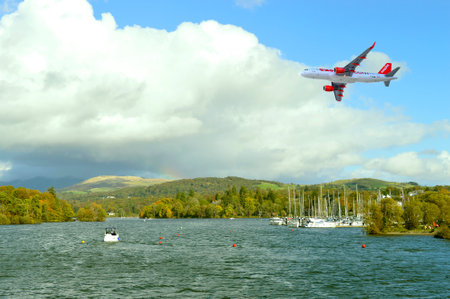 Easyjet Airbus A320 aircraft flying over Lake Windermere in Cumbria