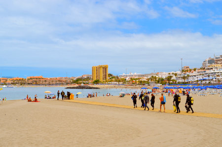 Los Cristianos beach, Tenerife, Canary Islands, Spain, Europe - June 13, 2016: Scuba divers on the beach walking to the seaのeditorial素材