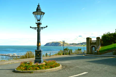 Historical Llandudno retro streetlight on a roundabout island in North Walesの写真素材