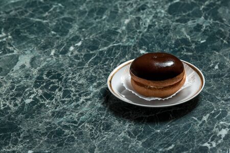 bush cake with saucer on green marble backgroundの写真素材