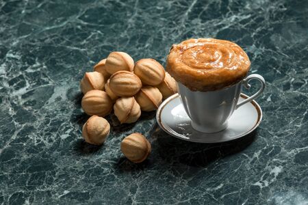 meat pie with saucer, black tea and cookie walnut on marble backgroundの写真素材