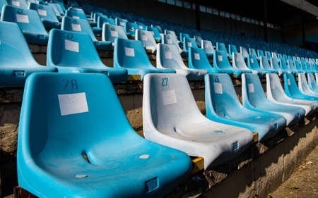 Old blue seats on an empty stadium for football fans