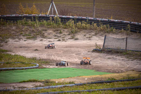 3 RC buggies racing on an outdoor trackの写真素材