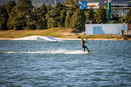 Young boy wakeboarding on a lakeの写真素材