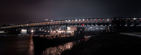 Panorama shot of a metal bridge in Bratislava during nightの写真素材