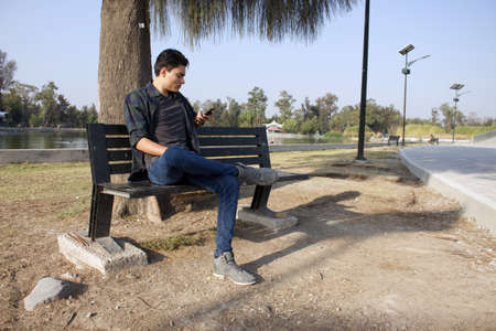 Latino teenager posing during the day in a forest.の写真素材