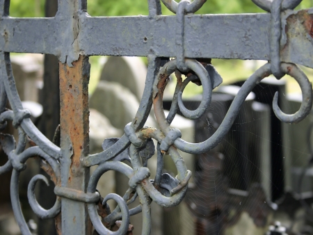 Rusty grave cross with a spider web on it の写真素材
