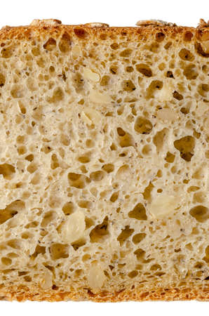 Slice of spelt bread, from above, close-up. Brown sourdough bread, mix of spelt flour, leaven,...