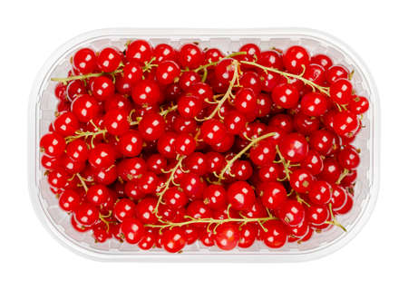 Redcurrant berries, in a plastic container. Fresh ripe red currant berries, spherical edible fruits...