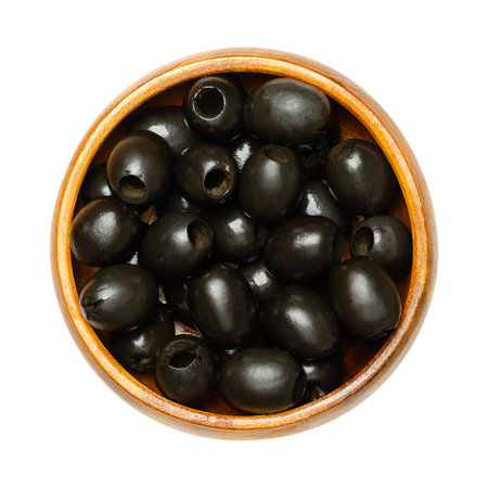 Hojiblanca, pitted black olives, in a wooden bowl. European olive, Olea europaea, a cultivar from...