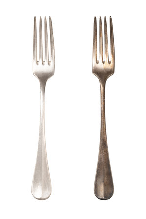 Polished and tarnished sterling silver fork handles, old and often used. Hydrogen sulfide and oxygen in the air react with the outermost layer of the metal.の写真素材