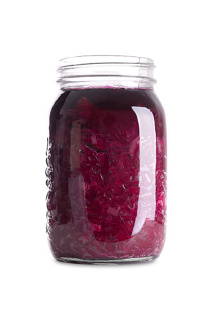 Red cabbage, homemade fermented German Blaukraut in a glass jar. Cut raw red cabbage, fermented by lactic acid bacteria. Unpasteurized and uncooked blaukraut provides probiotics.の写真素材