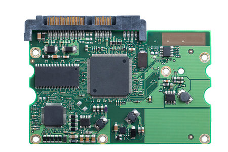 Printed circuit board, PCB of a hard disk drive, HDD, from above. Flat piece of layered fiberglass...