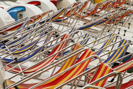 Row of colorful chaise lounge on beach. Multicolored in a row.の写真素材