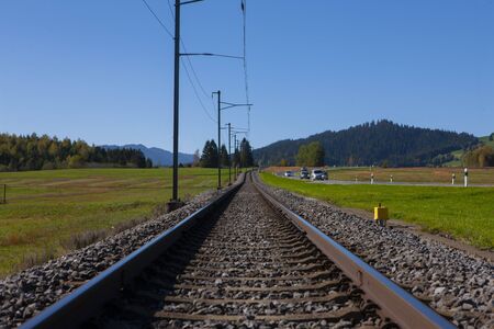 Railroad track in Switzerland converging in horizon. With clear blue skyの写真素材