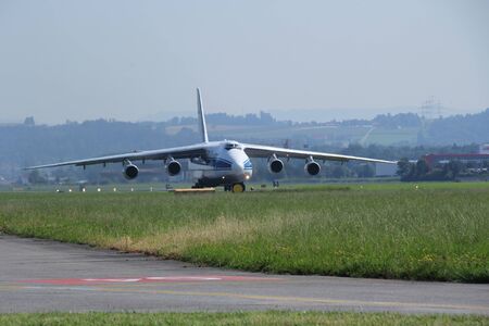 Antonow An 124 landing and off loading and taking off in Switzerland with blue skyの写真素材