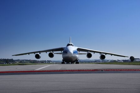Antonow An 124 landing and off loading and taking off in Switzerland, with blue skyの写真素材