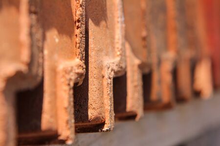 red roofing tiles lined up in a row. Close up of roofing timesの写真素材
