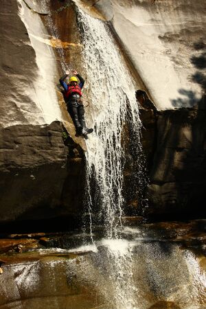Canyoning in Tessing, Man with helmet jumping in waterの写真素材