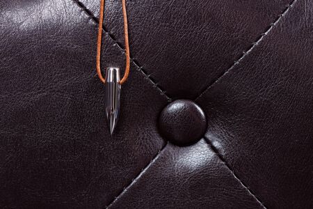 bullet lucky charm on leather couch with dark backgroundの写真素材