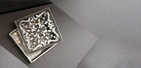 silver jewelery box on grey background with copy spaceの写真素材