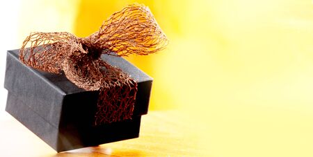 brown christmas present with ribbon. Presents in a table with decoration and copy space and a ribbonの写真素材