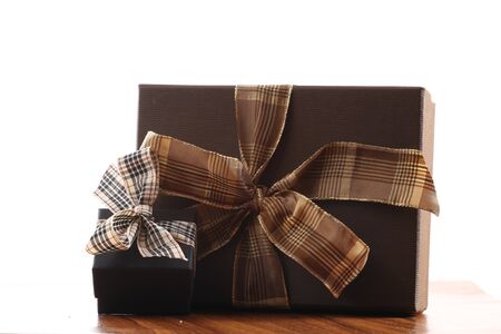Presents on a table with a bow. Background space for copy. For Christmas, birthday or other holiday cardsの写真素材