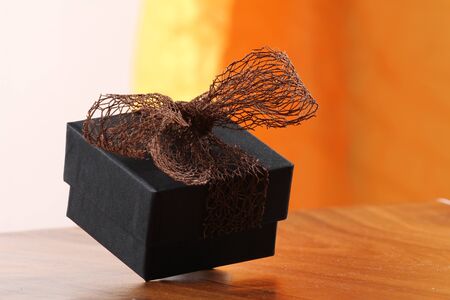 Presents on a table with a bow. Background space for copy. For Christmas, birthday or other holiday cardsの写真素材
