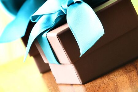 Presents on a table with a bow. Background space for copy. For Christmas, birthday or other holiday cardsの写真素材