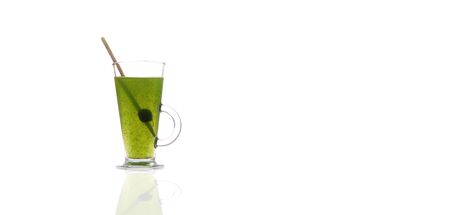 Glass with fresh wheat grass with clear water in a cup, with copy spaceの写真素材