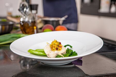 lifestyle cook presenting food in a white plateの写真素材