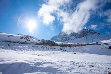 Alpine pass in switzerland, Julierpass in swiss alp with snow and cloudy skyの写真素材