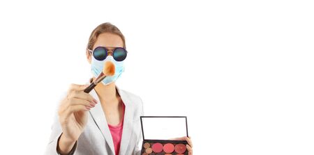 Pretty Make up Artist wearing face mask as protection from virus. Wearing sun glasses. with copy...