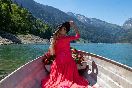 romantic scene with female model with long blond hair on a boat. Life style Shooting of a girlの写真素材