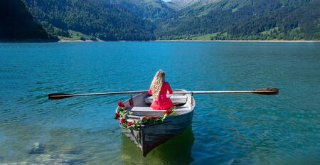 romantic scene with female model with long blond hair on a boat. Life style Shooting of a girlの写真素材